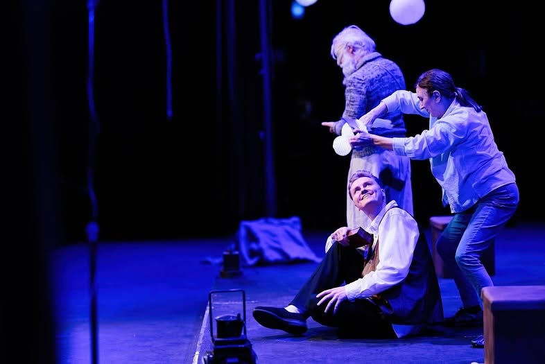 An actor looks up in awe at a flying bird puppet during Brightlight Theatre&rsquo;s production of Songkeeper.