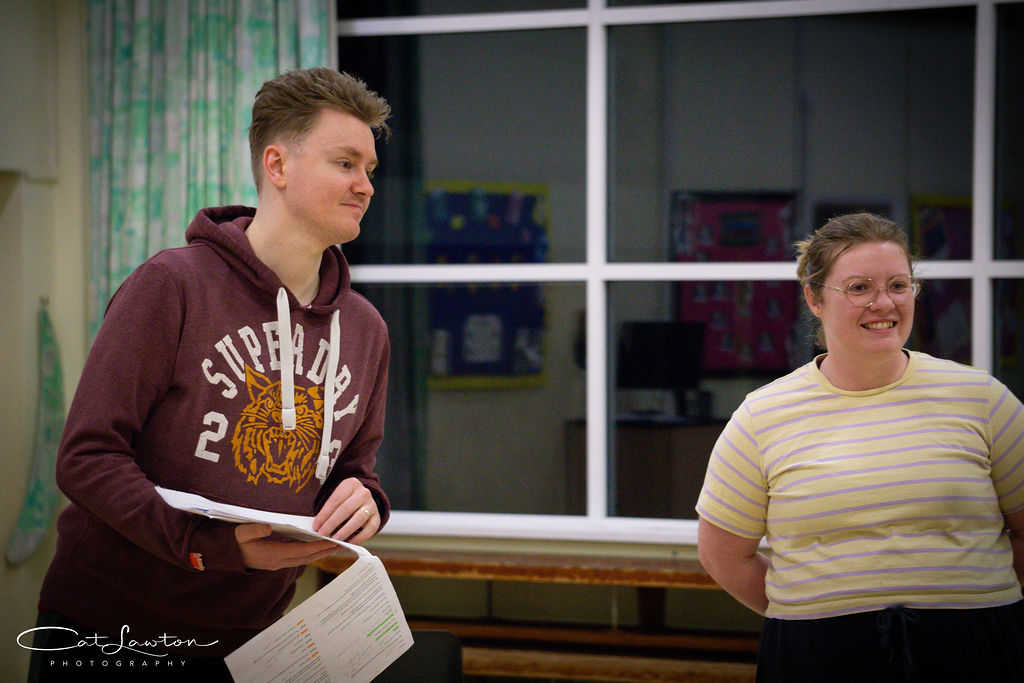 Two actors enjoy rehearsing a scene with Brightlight Theatre.