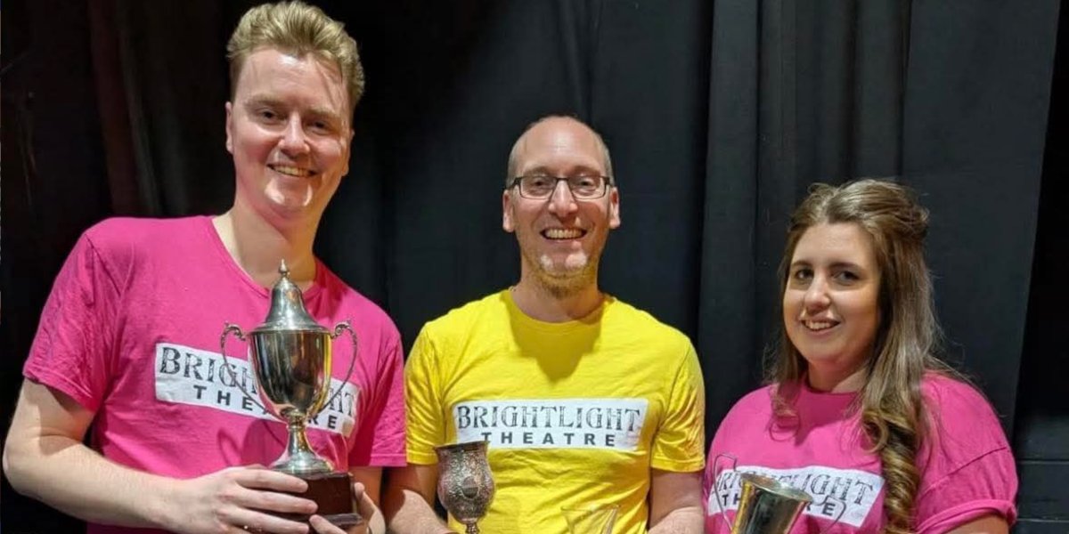 Three members of Brightlight Theatre accept awards for winning Henley Drama Festival.